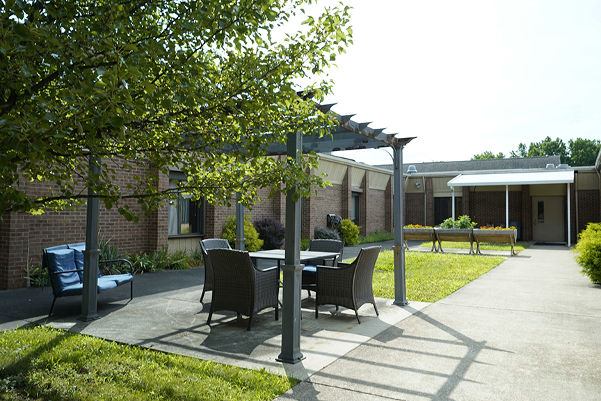 Chairs and table in outdoor courtyard- Arbors at Stow